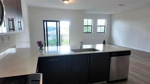 a room with a table chairs and wooden floor