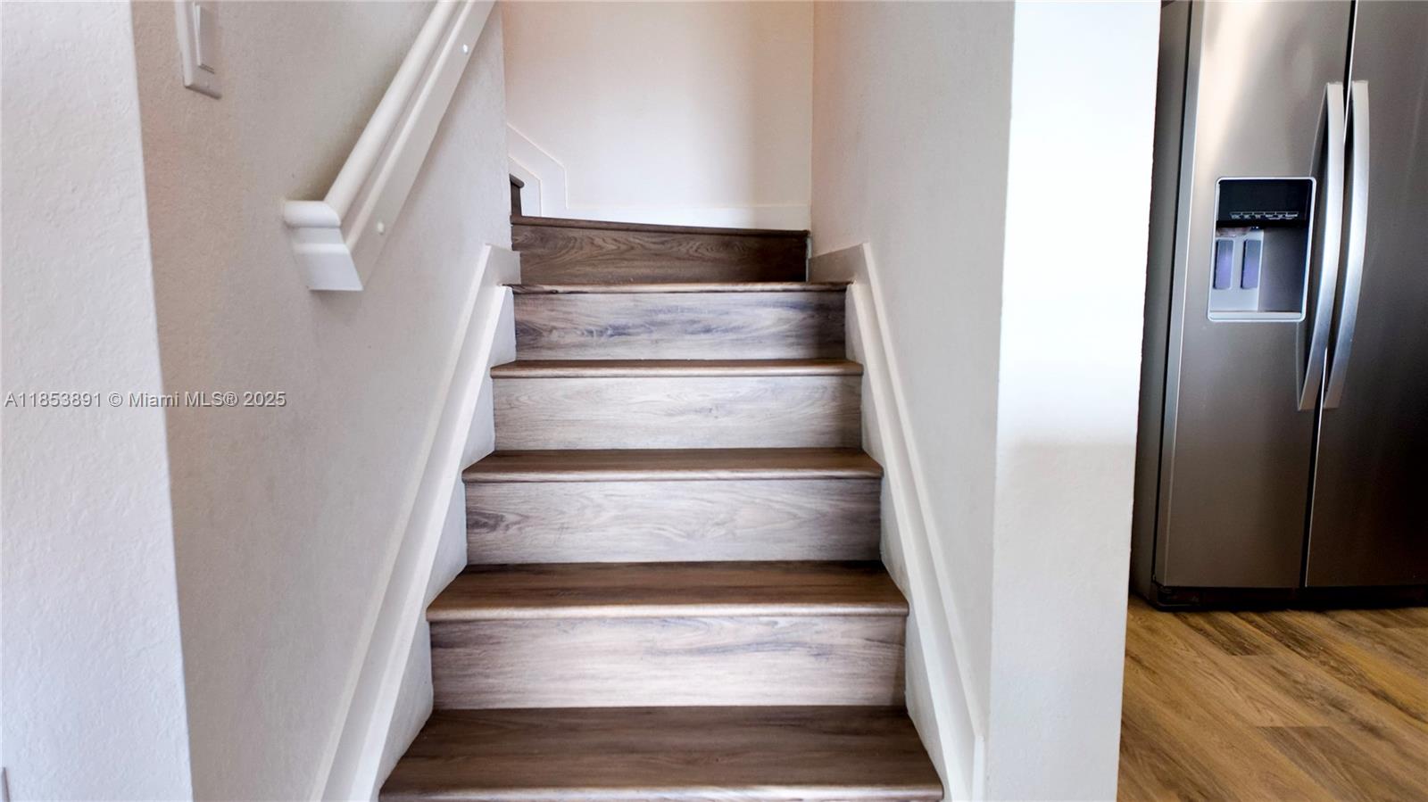 15560 Southwest 136th Street, Unit 3206 Miami, FL 33196 - Photo 9 of 18 a view of staircase with white walls and a rug