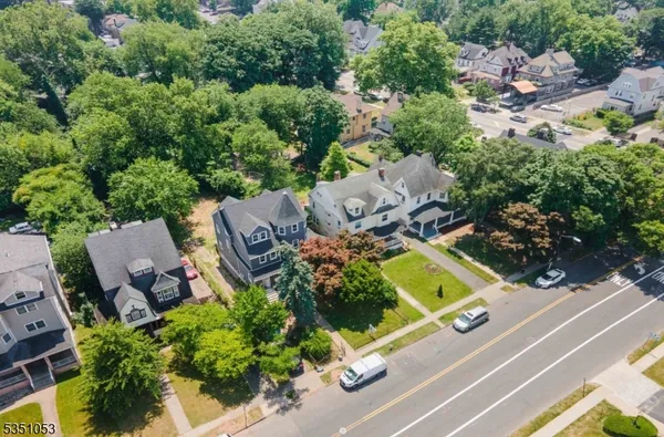 an aerial view of a house with garden space and street view