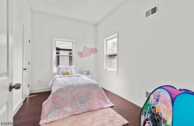 a bed room with a bed and a painting on the wall