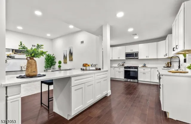 a kitchen with white cabinets and white appliances