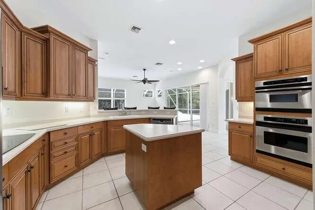 a kitchen with sink stove and cabinets