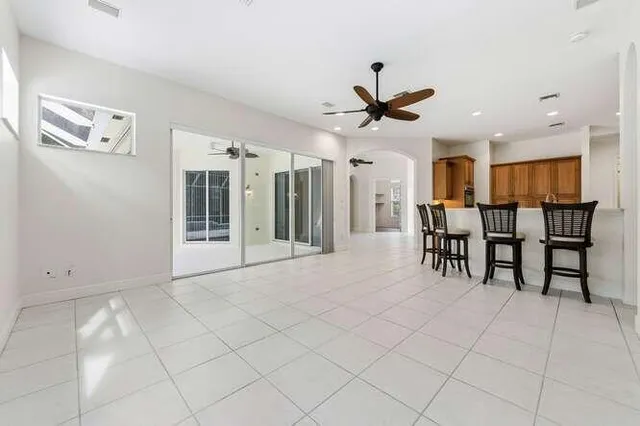 a view of a livingroom with furniture and a ceiling fan