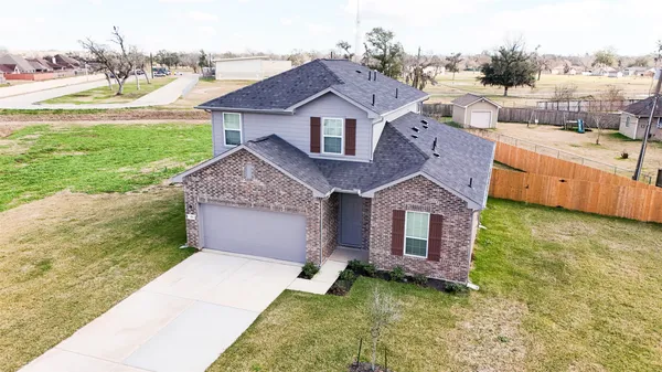 a aerial view of a house with a yard and a garage