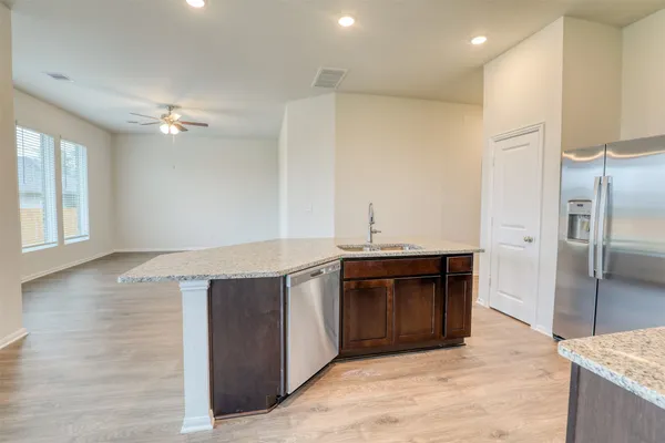a kitchen with stainless steel appliances granite countertop a refrigerator and a sink
