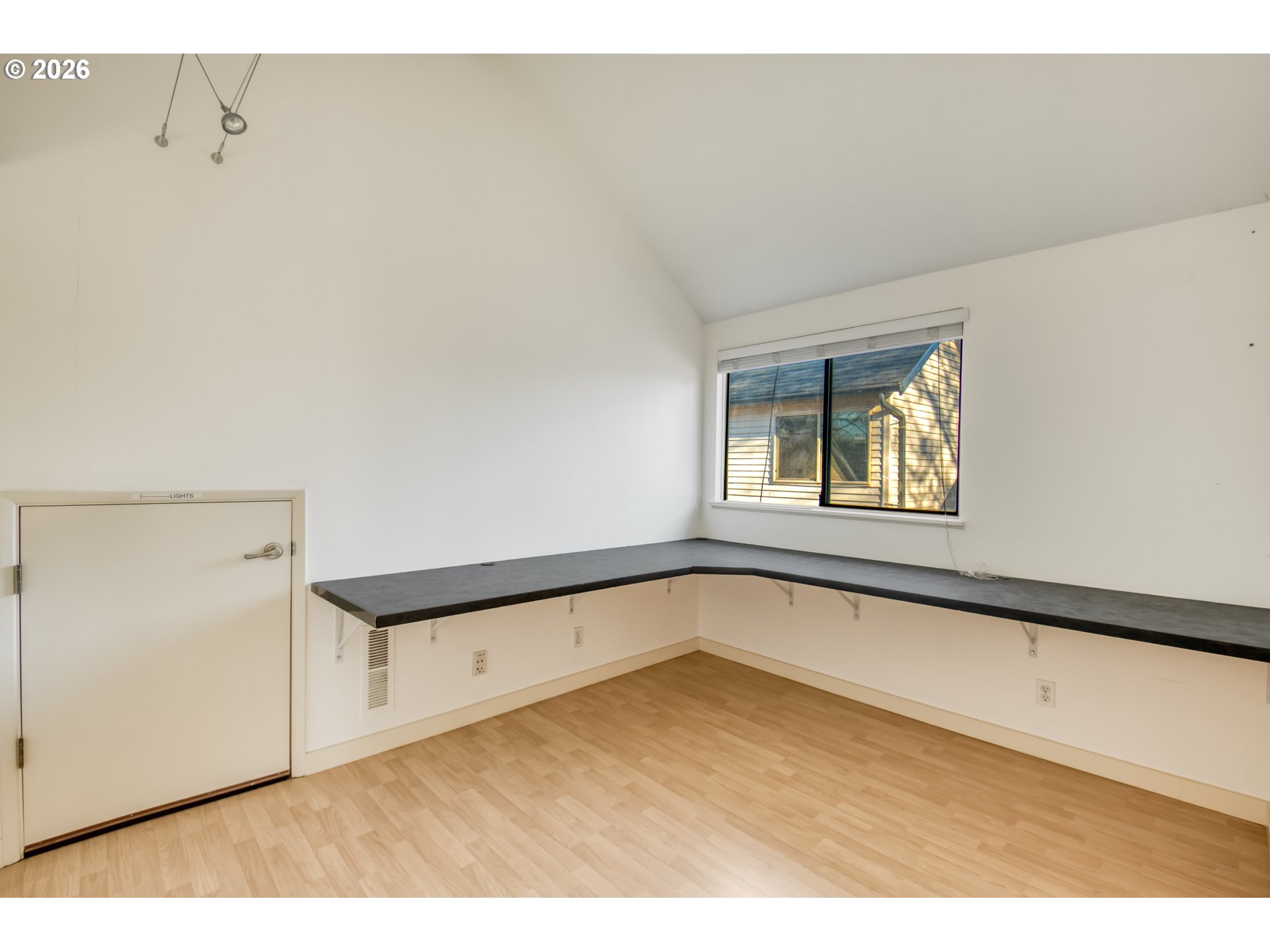 9731 Southwest London Court Portland, OR 97223 - Photo 17 of 27 a view of a room with a window and wooden floor