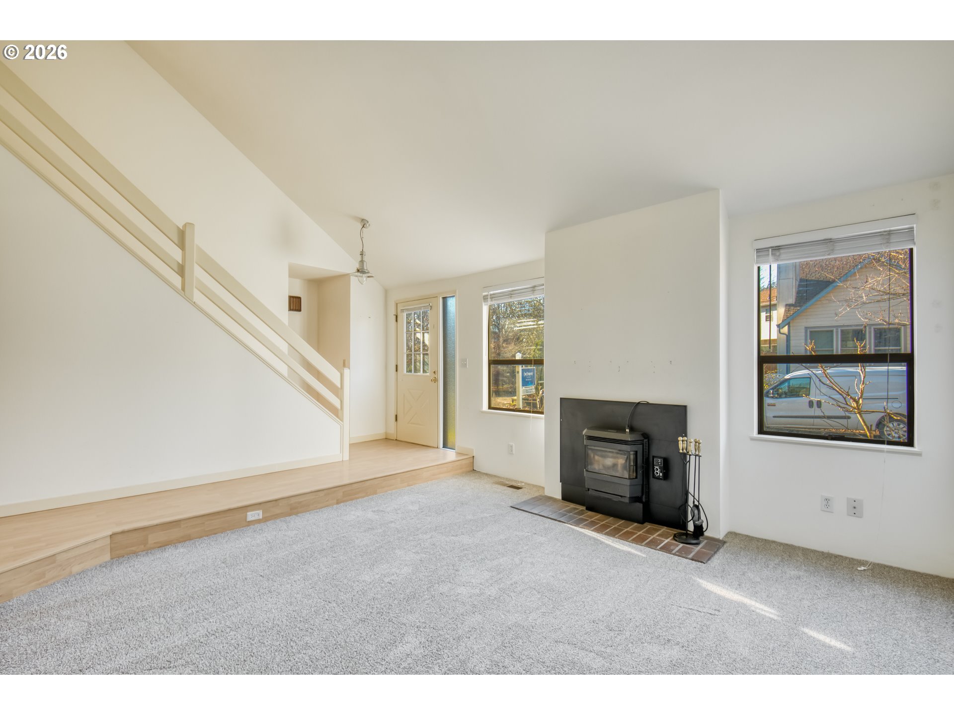 9731 Southwest London Court Portland, OR 97223 - Photo 6 of 27 a view of an empty room with a window and a kitchen
