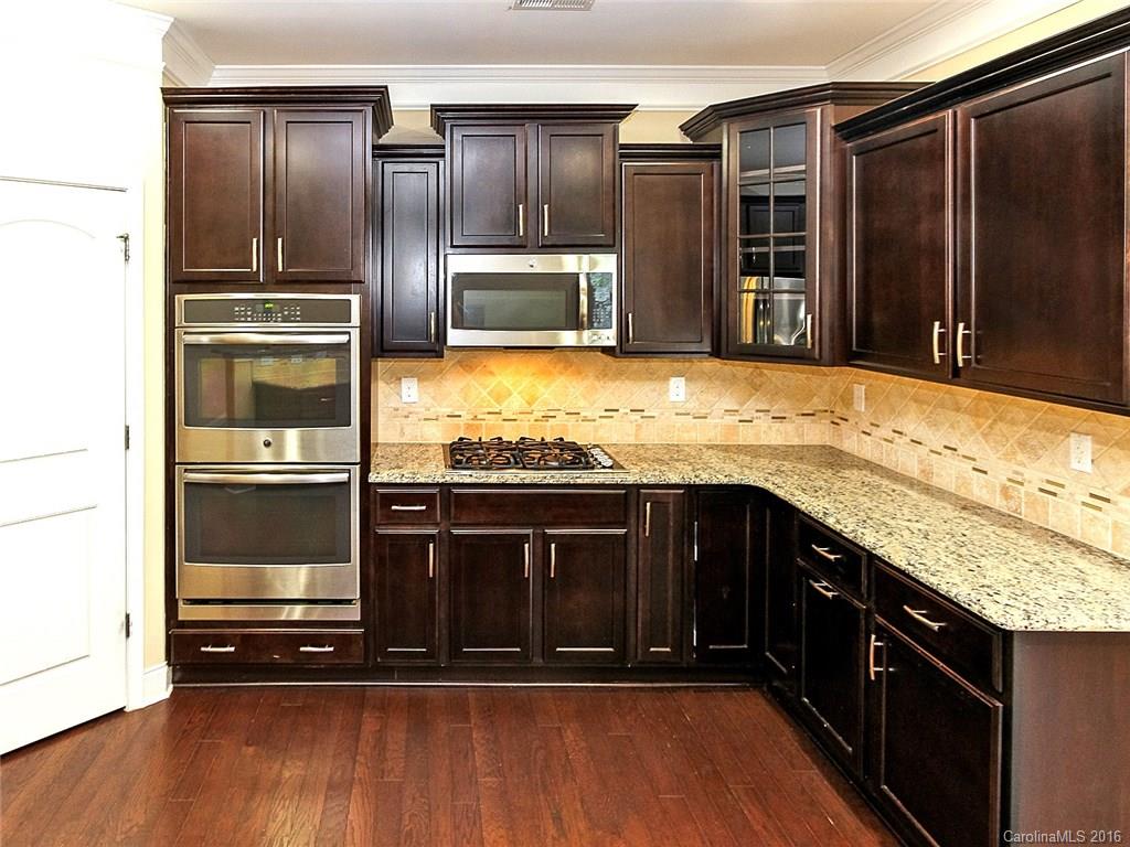 233 Annatto Way, Unit 553 Tega Cay, SC 29708 - Photo 2 of 22 a kitchen with stainless steel appliances granite countertop a stove and a refrigerator