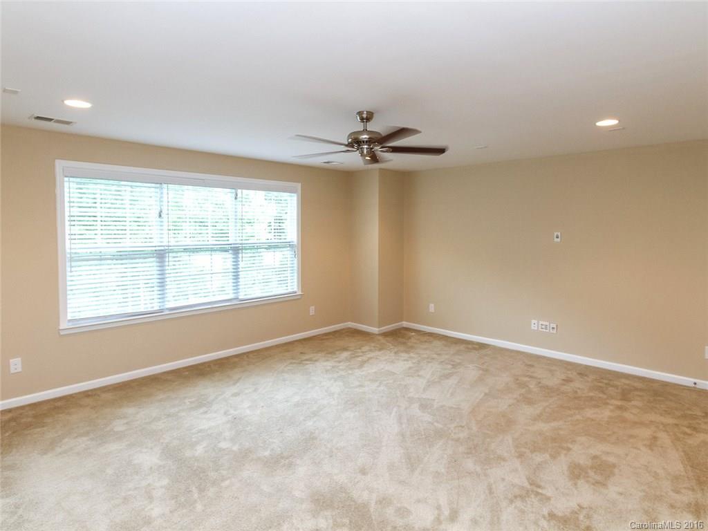 233 Annatto Way, Unit 553 Tega Cay, SC 29708 - Photo 12 of 22 an empty room with a window and a ceiling fan