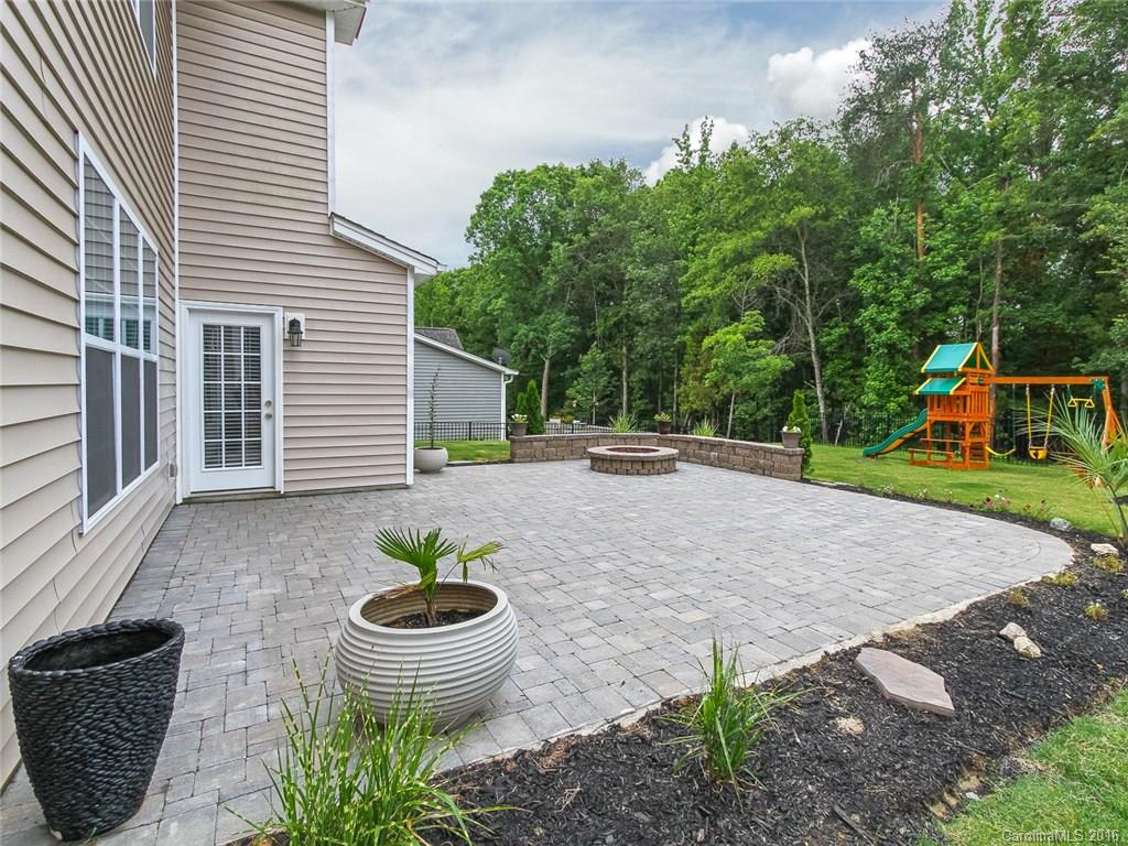 233 Annatto Way, Unit 553 Tega Cay, SC 29708 - Photo 19 of 22 a view of a backyard with chair and potted plants