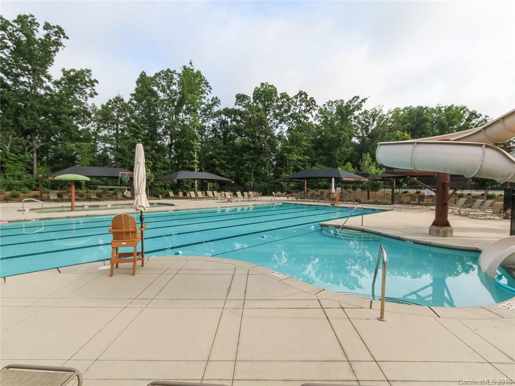 233 Annatto Way, Unit 553 Tega Cay, SC 29708 - Photo 22 of 22 a park with a bench and trees in the background