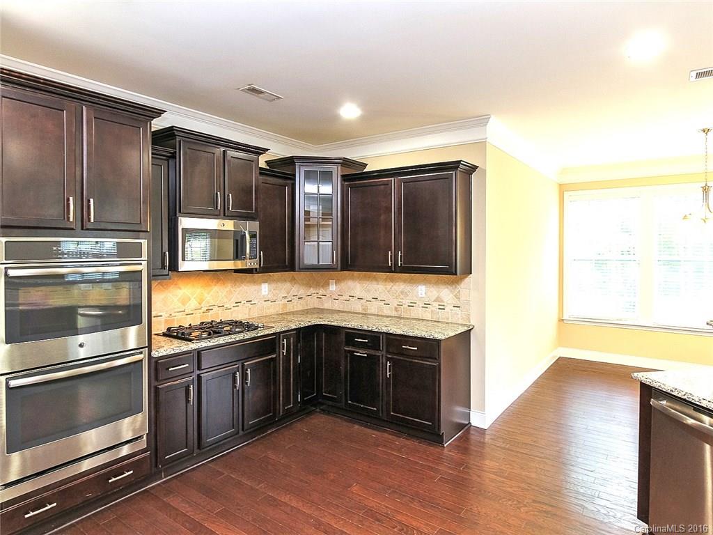 233 Annatto Way, Unit 553 Tega Cay, SC 29708 - Photo 4 of 22 a kitchen with stainless steel appliances granite countertop a stove and a sink