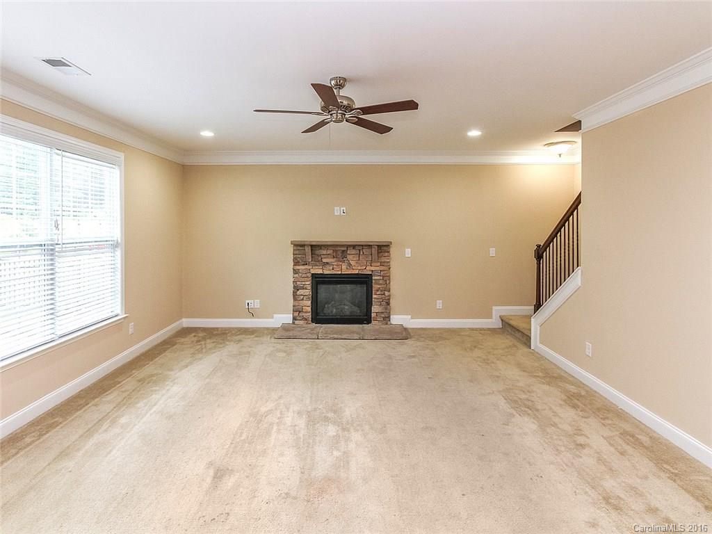 233 Annatto Way, Unit 553 Tega Cay, SC 29708 - Photo 8 of 22 a view of an empty room with a fireplace and a window