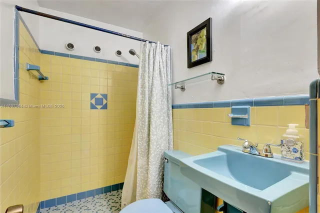 a bathroom with a sink mirror vanity and toilet