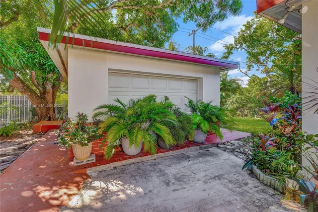 a view of a house with potted plants