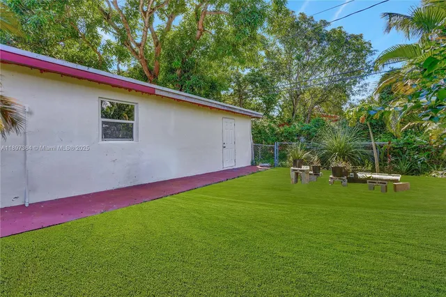 a backyard of a house with table and chairs
