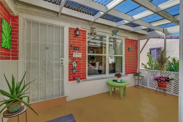 a view of a room with chairs and potted plants