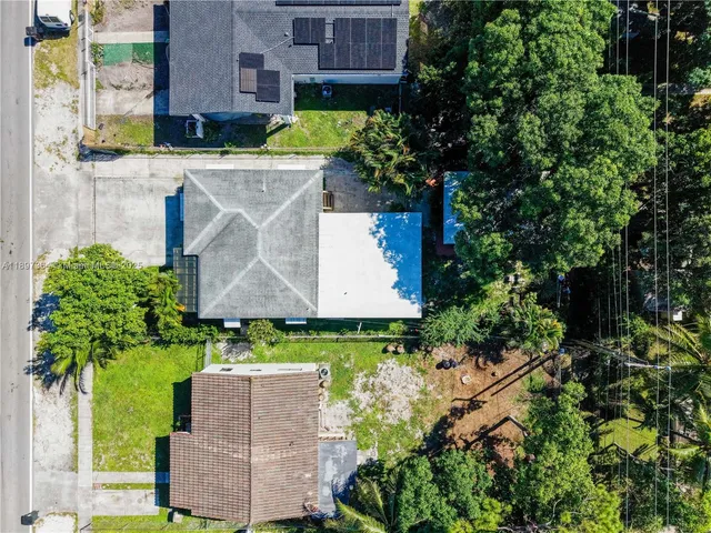 an aerial view of a house with a yard and garden