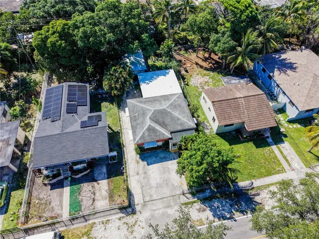 an aerial view of a house with garden space and street view