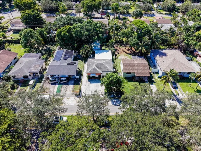 an aerial view of a house with a yard and lake view