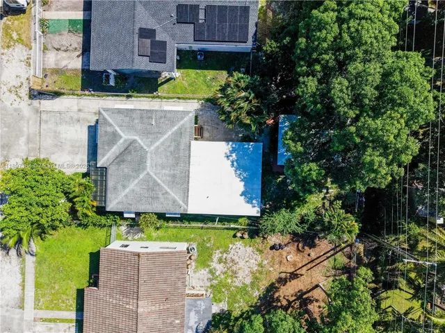 an aerial view of a house with a yard and a fountain