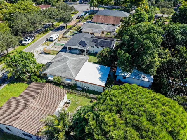 an aerial view of a house with garden space and street view