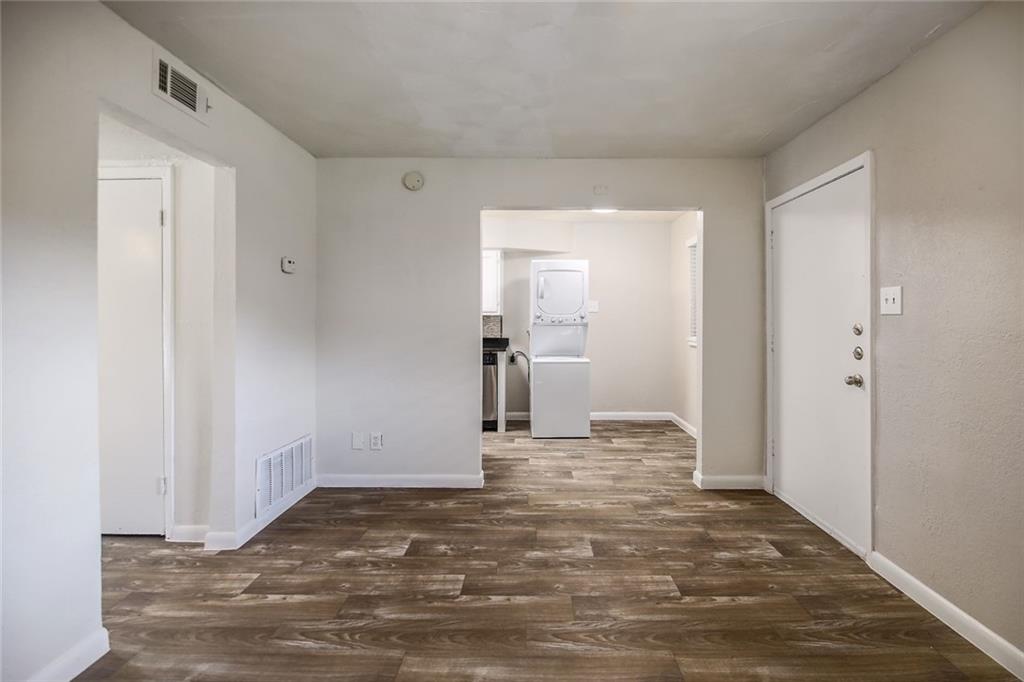 2401 Manor Road, Unit 221 Austin, TX 78722 - Photo 6 of 21 Hardwood-style flooring extends into an open concept layout with an in-unit washer and dryer.