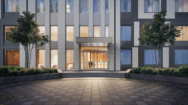 front view of a brick house with a yard