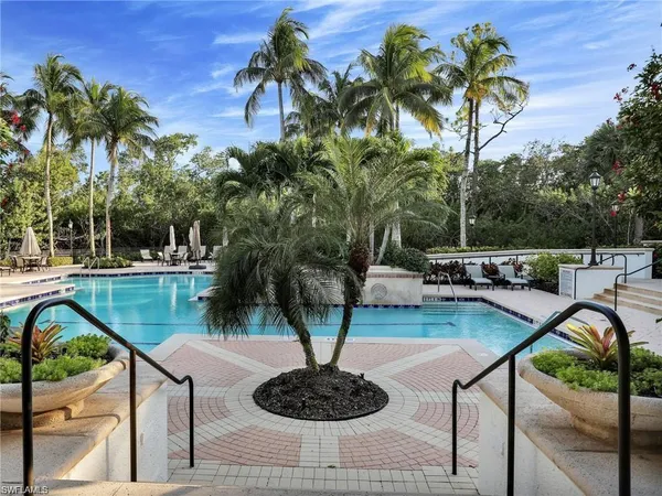 a view of a swimming pool with a patio and a yard