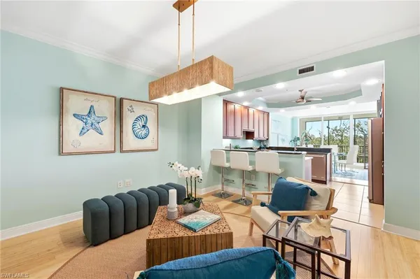 a living room with furniture and kitchen view