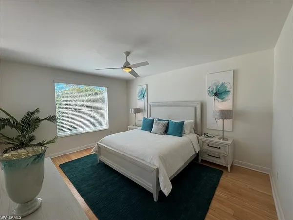 a bedroom with a large bed and a window
