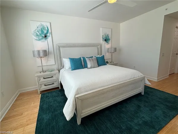 a large bed sitting in a bedroom and table