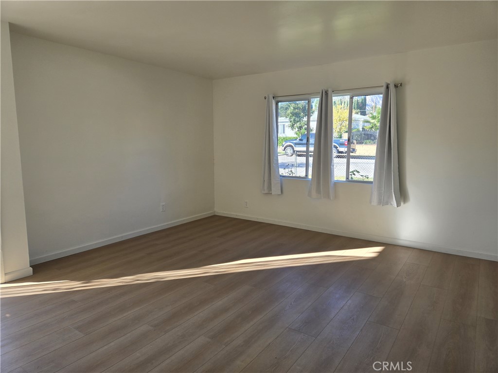 1734 Atchison Street Pasadena, CA 91104 - Photo 4 of 19 an empty room with wooden floor and windows