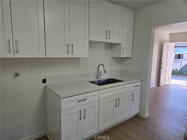 a kitchen with white cabinets and a sink