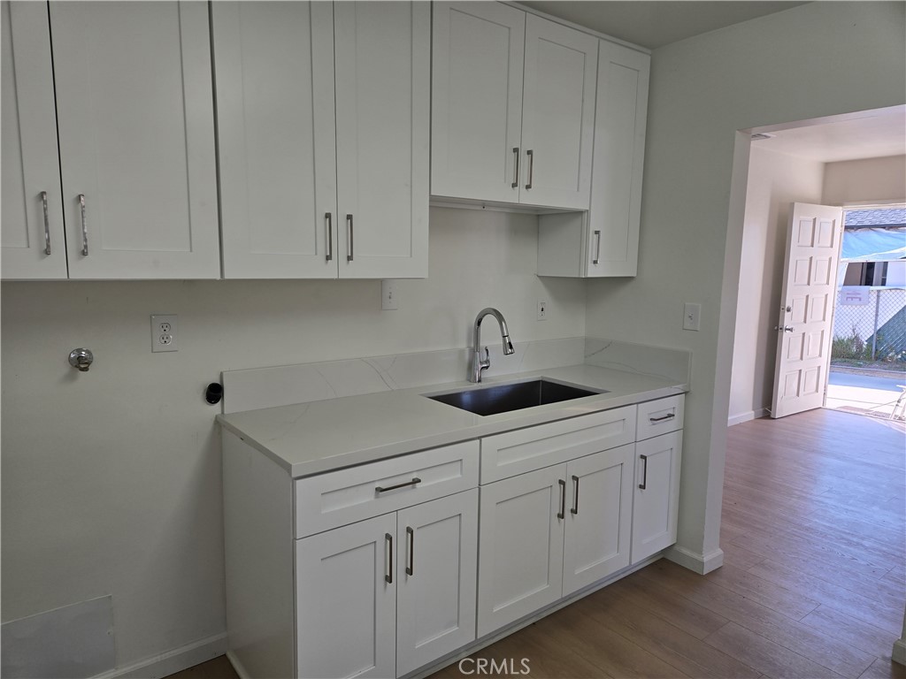 1734 Atchison Street Pasadena, CA 91104 - Photo 6 of 19 a kitchen with white cabinets and sink