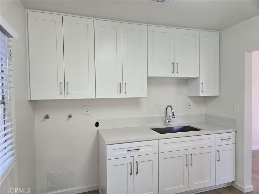 1734 Atchison Street Pasadena, CA 91104 - Photo 7 of 19 a kitchen with white cabinets and a sink