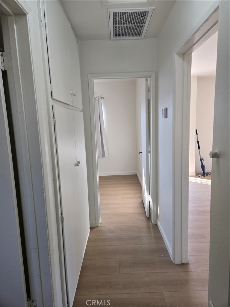 1734 Atchison Street Pasadena, CA 91104 - Photo 10 of 19 a view of a hallway with wooden floor and closet area
