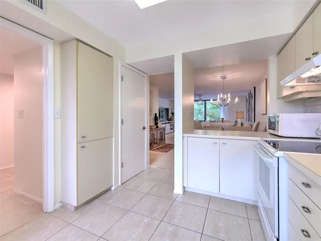 a kitchen with granite countertop a sink and cabinets