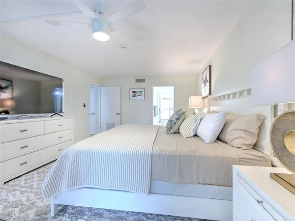 a large white bed in a white room