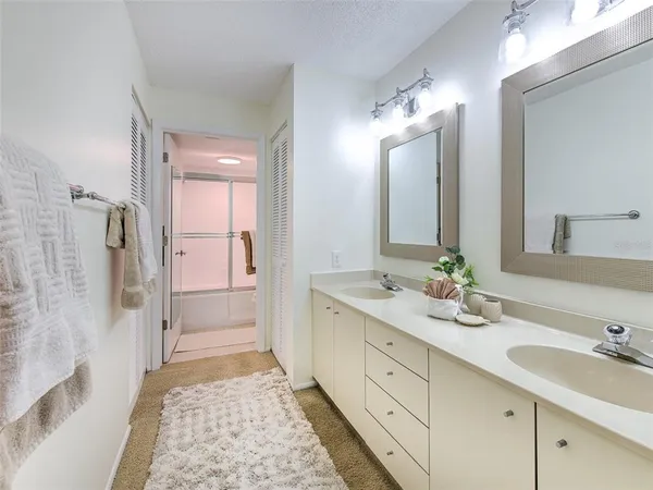 a en suite bathroom with double sink and a mirror