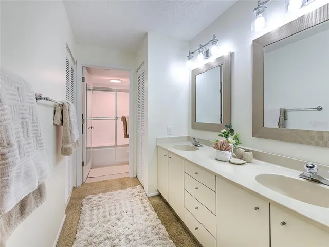 a en suite bathroom with double sink and a mirror