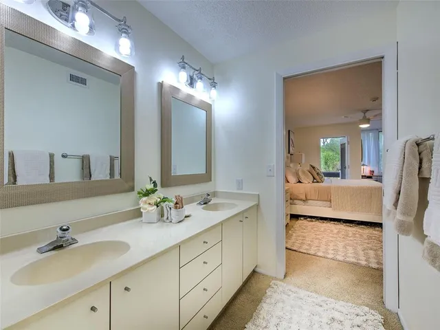 a bedroom with two beds and windows