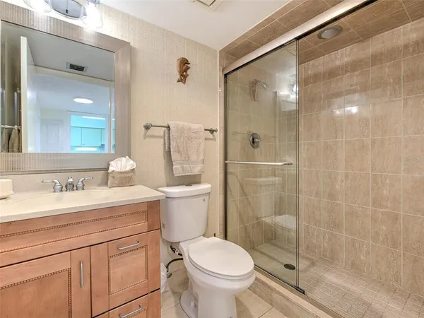 a bathroom with a sink toilet and shower