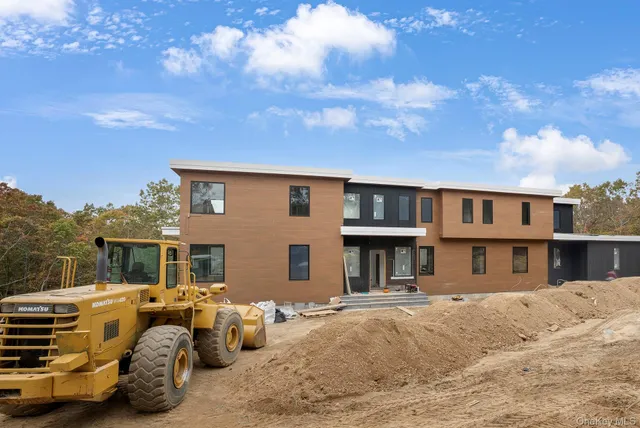 a backyard of a house with barbeque oven and outdoor seating