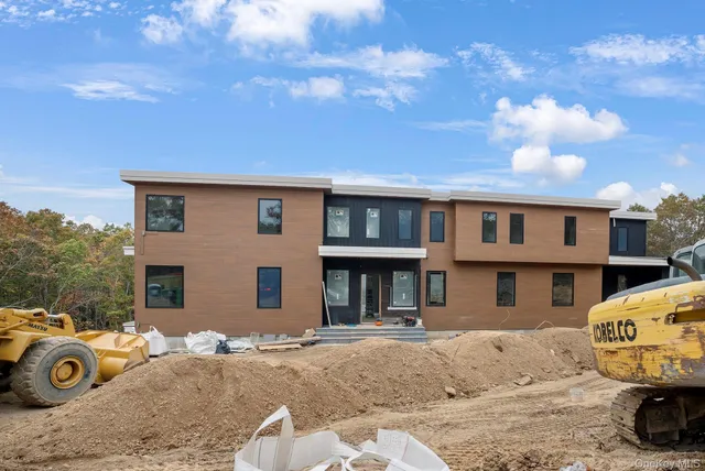 a front view of a house with trees