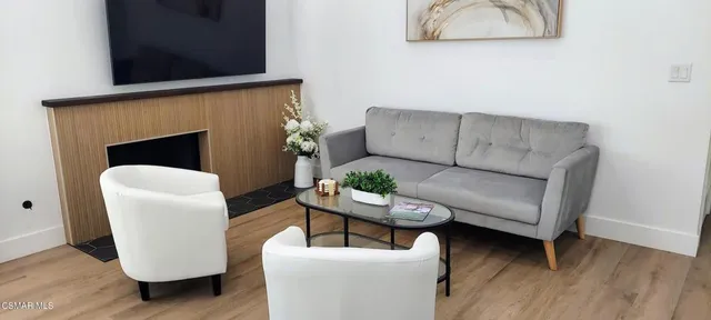 a view of a workspace with furniture and window