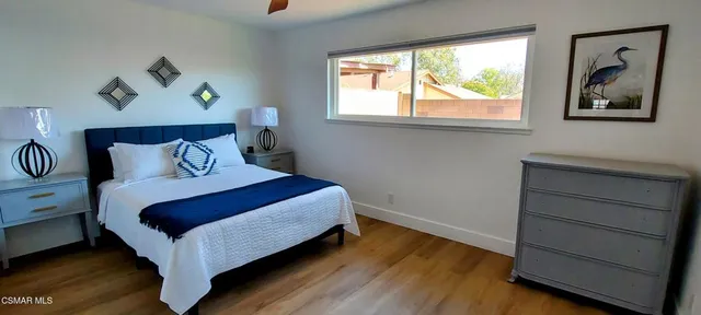 a bathroom with a granite countertop toilet sink and mirror