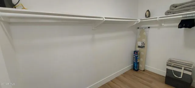 a bedroom with a bed and a chair