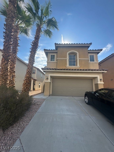6240 Senegal Haven Street North Las Vegas, NV 89081 - Photo 1 of 5 Mediterranean / spanish-style house featuring driveway, stucco siding, and a garage