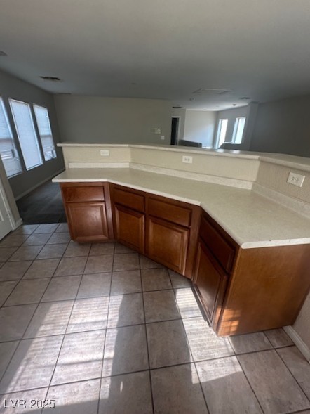 6240 Senegal Haven Street North Las Vegas, NV 89081 - Photo 4 of 5 Kitchen with light countertops, brown cabinets, and light tile patterned floors